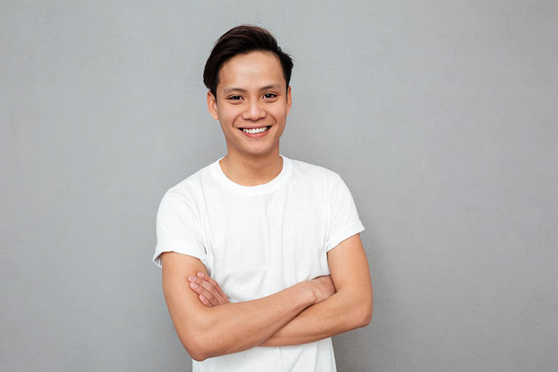 Smiling software engineer with arms crossed